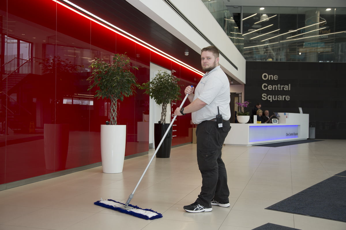 person sweeping in Hugh James